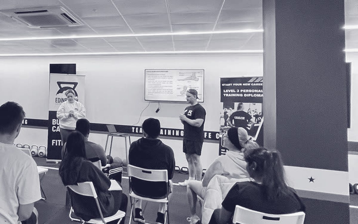 A tutor teaching a group of students at Edinburgh PT Academy