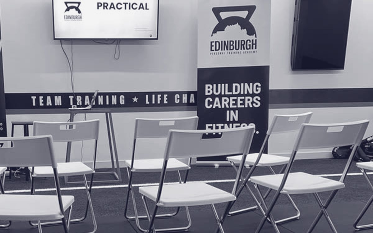 Edinburgh PT Academy classroom with a Building Careers in Fitness banner